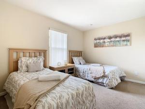 a bedroom with two beds and a window at Old Town Retreat At Regal Oaks By Mid Florida Home Management in Orlando