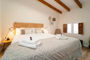 a bedroom with a large bed with towels on it at Modern Loft in the vibrant coast of Villajoyosa in Villajoyosa