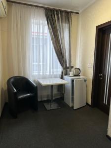 a room with a table and a chair and a window at Колібрі in Reni