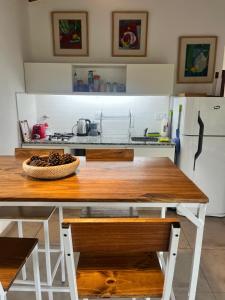 a kitchen with a wooden table and a refrigerator at Flor Silvestre in Carpintería
