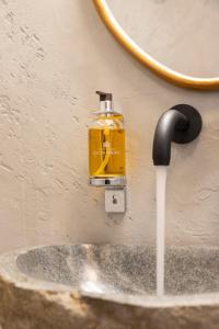 a soap dispenser on a wall next to a sink at Athens Top Penthouse With Spa 5' to Metro in Athens