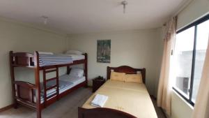 a bedroom with two bunk beds and a window at Hotel Shekinah Internacional in Esmeraldas