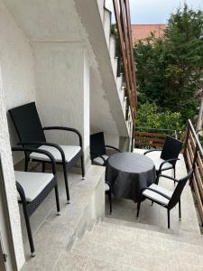 a patio with chairs and a table on a balcony at Apartment Majda in Rab