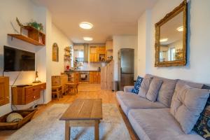 a living room with a couch and a table at 1 Bedroom Natural Condo in Sofia