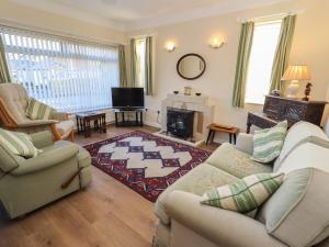 a living room with two couches and a fireplace at 4 Venables Road in Chester