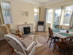 a living room with a table and chairs and a fireplace at 4 Venables Road in Chester