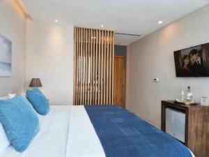 Rúm í herbergi á Hotel Perla Spondylus
