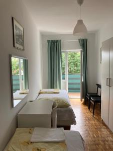 a bedroom with two beds and a view of the water at Apartment Majda in Rab