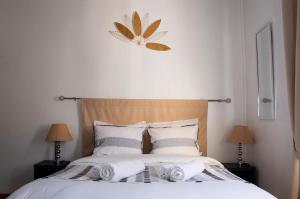 Postel nebo postele na pokoji v ubytování Hôtel Le Tivoli