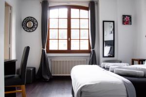 Postel nebo postele na pokoji v ubytování Hôtel Le Tivoli