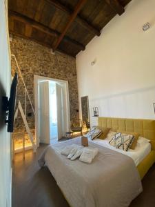 a bedroom with a large bed with two towels on it at Calamarina B&B in Vietri