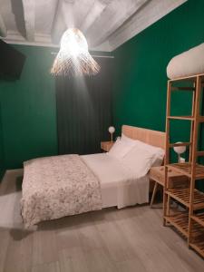 a bedroom with a bed and a green wall at Residenza Sant'Andrea Smeraldo in Chioggia