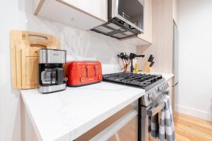 a kitchen with a red coffee maker on a counter at 323-1 Specious 2BR Williamsburg in Brooklyn