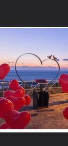 a bird flying over the ocean with a heart shape at Suites Luisa Sanfelice in Agropoli