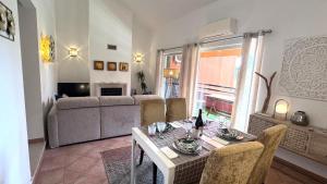 a living room with a table and a couch at Oasis of Aroeira Golf & Beach House in Aroeira