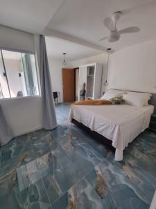 a bedroom with a bed and a blue floor at Pousada del Sole in Angra dos Reis