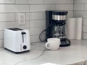 a toaster and a coffee cup on a kitchen counter at Quiet & Peaceful Home Close to LA/Beaches/Disney in Rosemead
