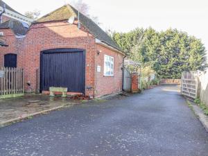 a brick house with a gate and a garage at The View in Faversham