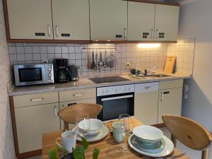 a kitchen with a table with dishes on it at Ferienwohnung Eva in Radebeul