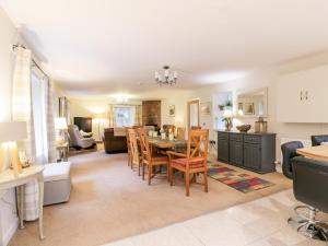 a kitchen and living room with a table and chairs at Oakbank in Dumfries
