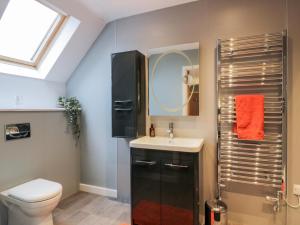 a bathroom with a toilet and a sink and a shower at Oakbank in Dumfries +43 photos