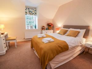 a bedroom with a large bed and a window at Oakbank in Dumfries