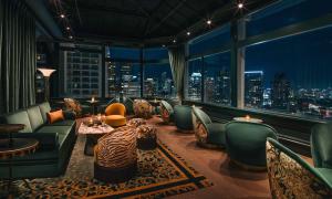 a hotel lobby with a view of a city at night at Beacon Grand, A Union Square Hotel in San Francisco