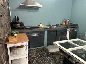 a kitchen with a sink and a counter top at Quiet Place in Machico