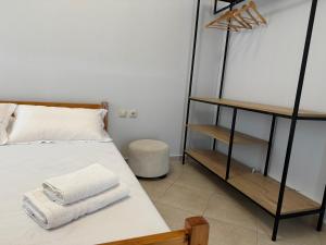 a bedroom with a bed with towels on it at Kylian Apartments in Sarandë