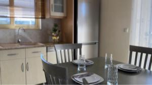 a kitchen with a table and chairs and a table and chairsktop at Kylian Apartments in Sarandë
