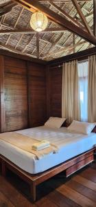 a large bed in a room with a ceiling at UKCC (Ujung Karang Conference Center) in Sabong