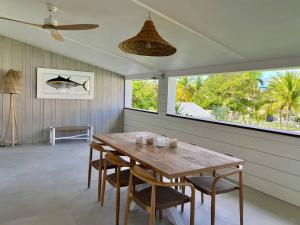 a dining room with a wooden table and chairs at NEW! Appartement « CASA PAPA » in Anse Marcel 