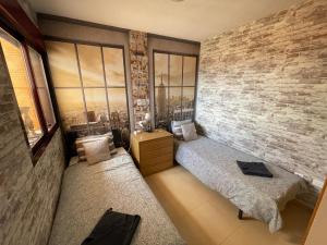 a bedroom with a bed and a brick wall at Amazing Sea View! in Isla Plana