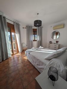 a bedroom with two beds and a mirror at Chalet La Noria in Nerja