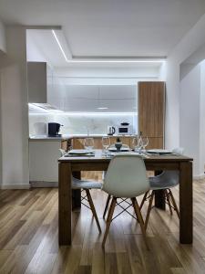 Un comedor con mesa y sillas de madera. en 2E Apartment Myslym Shyri, en Tirana