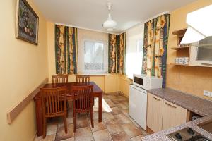 a kitchen with a table and chairs in a room at Irenos Svetaine in Palanga