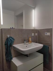 a bathroom with a sink and a mirror at Gästezimmer La Siesta in Ötisheim