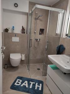 a bathroom with a shower and a toilet and a sink at Gästezimmer La Siesta in Ötisheim