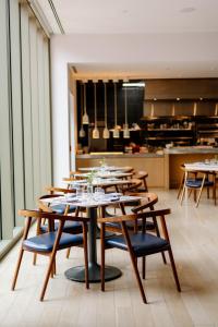 a group of tables and chairs in a restaurant at Quirk Hotel Charlottesville in Charlottesville