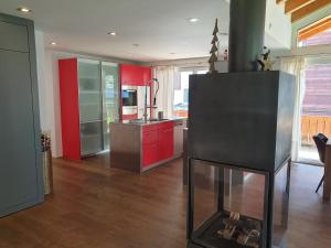 a kitchen with a fireplace in the middle of a room at Apartment Windward in Zermatt