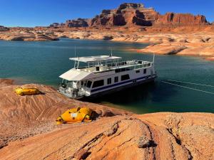 a boat in the middle of a river in the desert at Lake Canyon Getaway! in Page