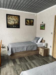 a bedroom with two beds in a room at 4 PORY ROKU POKOJE GOŚCINNE in Kamesznica