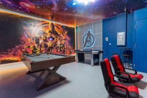 a room with a ping pong table and a mural at 150 Stunning 4BD Perfect for Your Vacation in Davenport