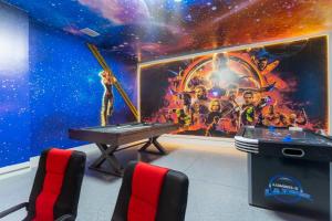 a ping pong table in a room with a space mural at 150 Stunning 4BD Perfect for Your Vacation in Davenport