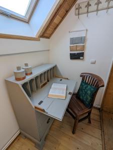 an attic office with a desk and a chair at Walimka in Walim