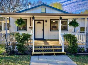 a house with a white door and a porch at Songbird Haven Cozy Country Getaway in Waco