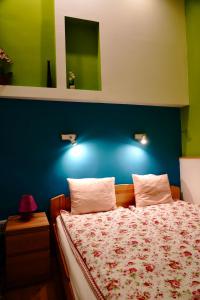 a bedroom with a bed with a blue wall at Blue home in the heart of Budapest in Budapest