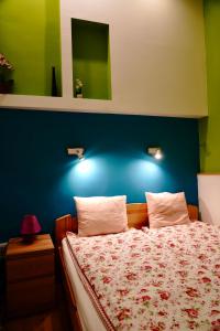 A bed or beds in a room at Blue home in the heart of Budapest