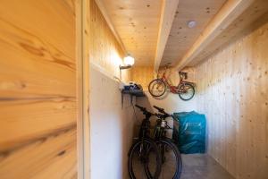 two bikes hanging on a wall in a tiny house at Ferienwohnungen Lanserhof in Appiano sulla Strada del Vino