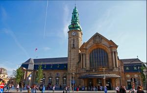 a large building with a clock tower in front of it at Elegant Spacious Room with Open Kitchen, Steps from Luxembourg Train Station in Luxembourg